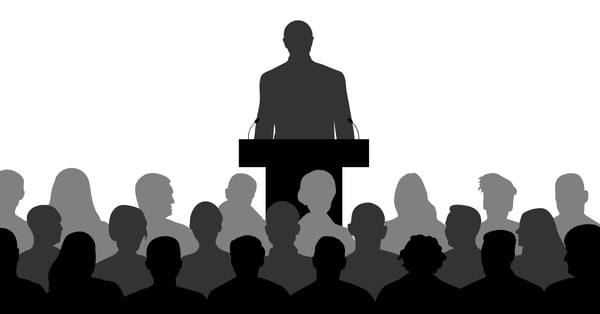 Figura de líder política en podio dando discurso