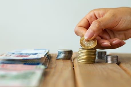 hand-holding-mexican-coin