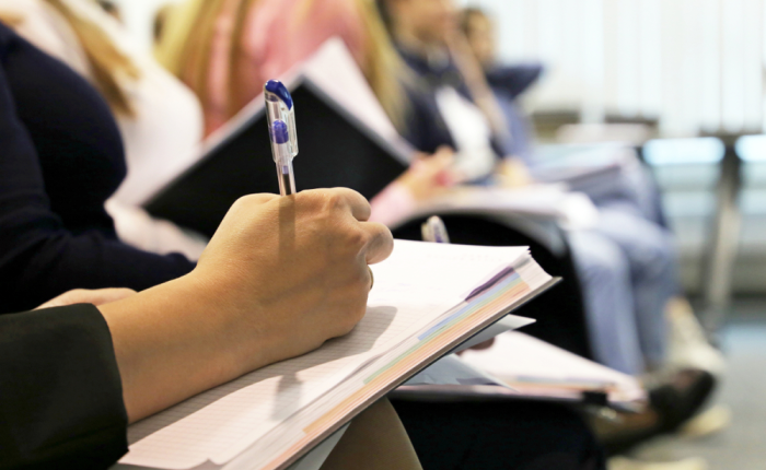 Pedagoga toma notas en reunión educativa