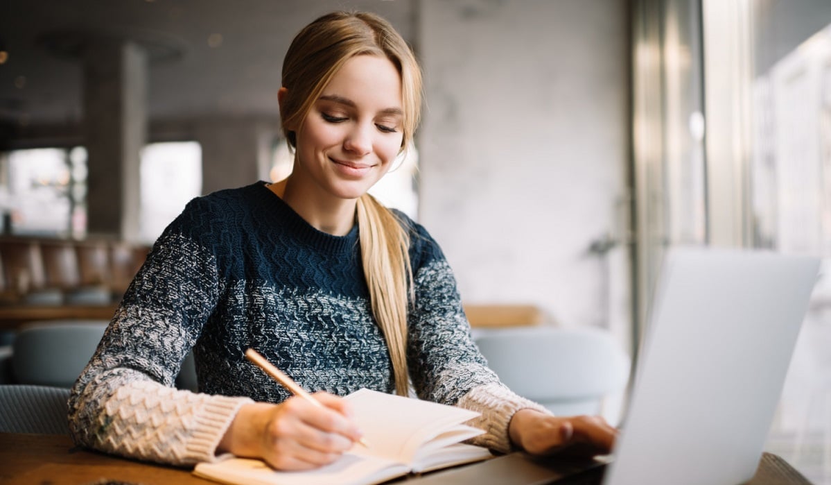 student-studying-using-laptop-computer-online-education-beautiful-woman-freelancer-writes-notes-planning-working-project-working-from-home